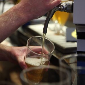 Barman Pouring Tasy Craft Beer at Independent Craft Brewery